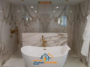 Private soaking tub with a custom shower and private lighting - Foukas Plumbing