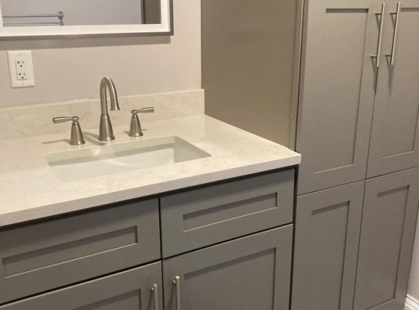 Gray bathroom vanity and linen cabinet